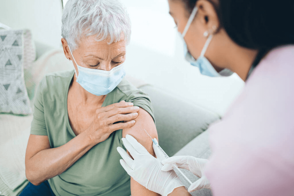 stock-photo-tomorrow-take-care-itself-doctor-giving-masked-older-woman-injection